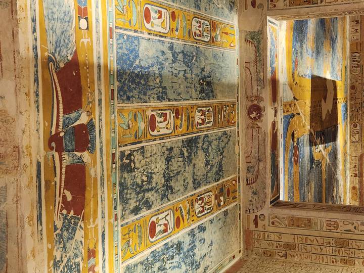 Colorful, well-preserved hieroglyphic ceiling art adorns the interior of an ancient Egyptian tomb.