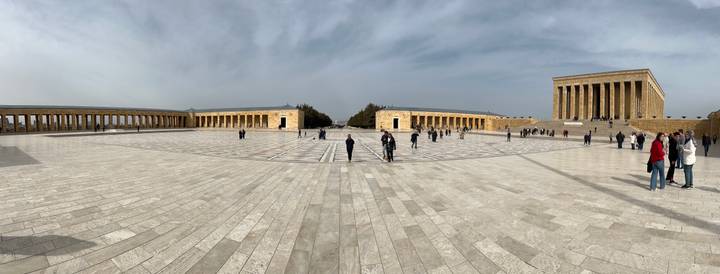 Wide marble plaza of Anıtkabir mausoleum complex with visitors scattered across the expansive square.