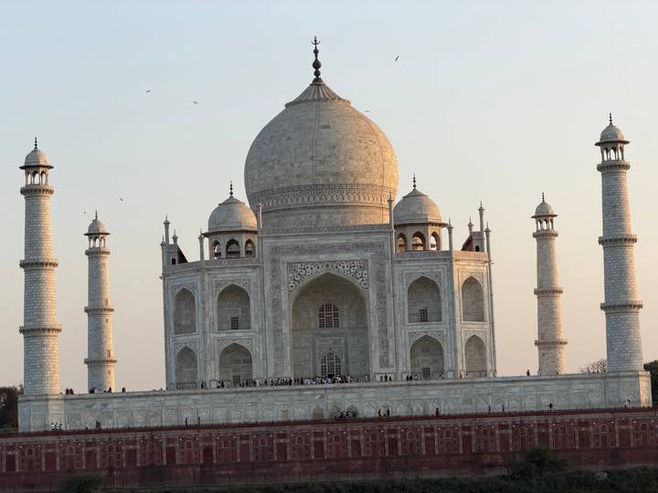 Close-up of the full Taj Mahal complex glowing in golden hour light with minarets towering.