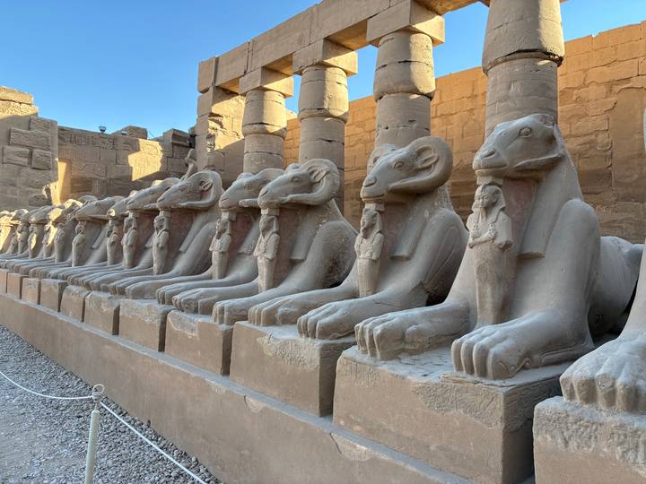 Row of ram-headed sphinx statues lining the avenue at Karnak Temple in Luxor