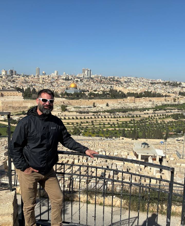 Visitor posing at panoramic viewpoint over Jerusalem with the golden Dome of the Rock