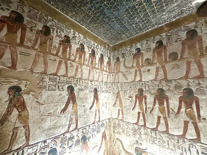 Colorful reliefs and hieroglyphs decorating the walls of an ancient Egyptian tomb chamber
