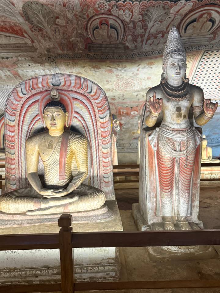 Intricately painted Buddha statues inside the ancient Dambulla Cave Temple.