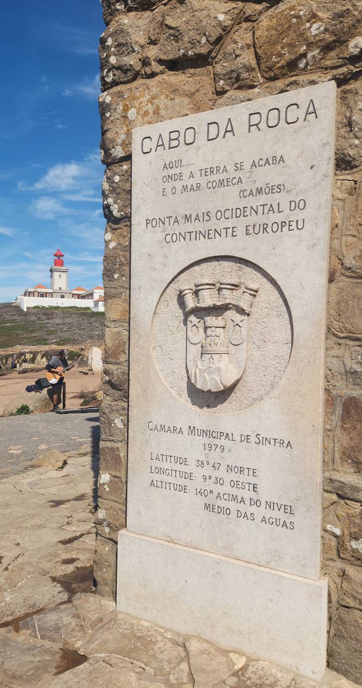 Stone crest reading 'Camara Municipal de Sintra' with a coastal lighthouse and guitarist in the background.