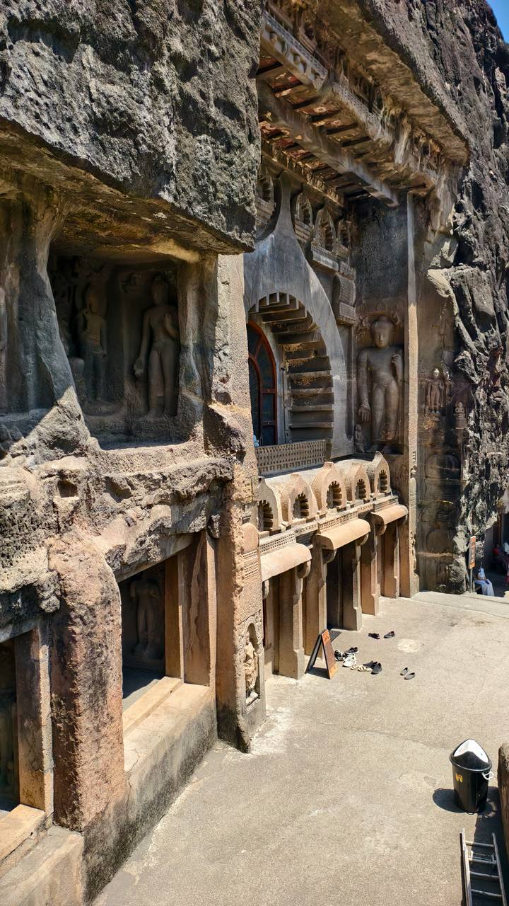 Detailed stone carvings and pillars on the façade of an Ajanta cave temple.