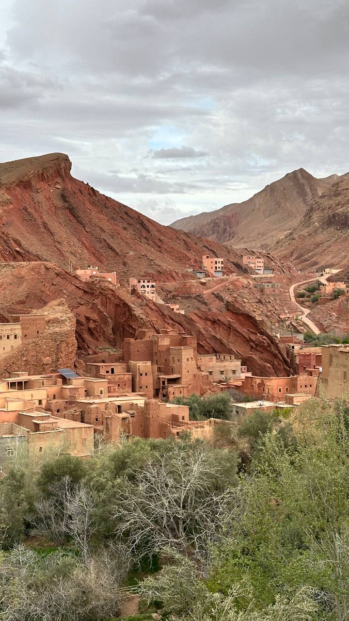 Berber clay village built into dramatic red mountains and ravines.