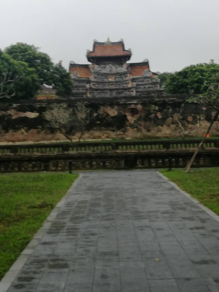 Out-of-focus image of a stone wall and walkway in a garden setting