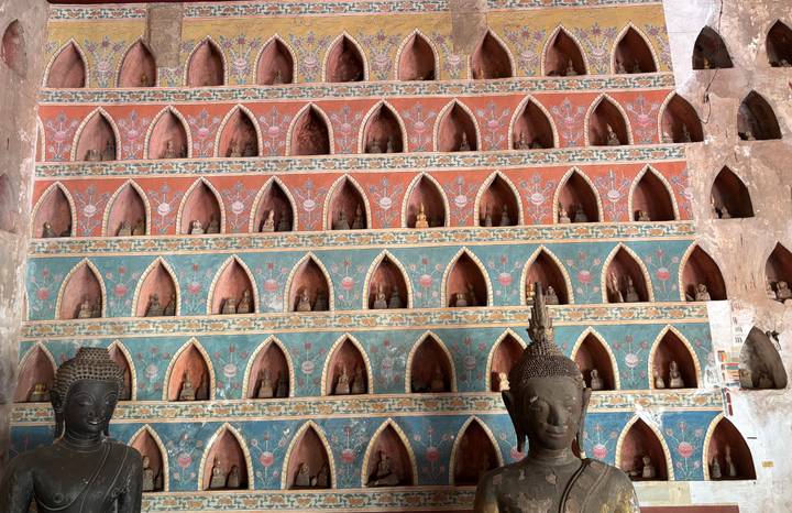 Multi-coloured wall of tiny Buddha niches inside Wat Sisaket.