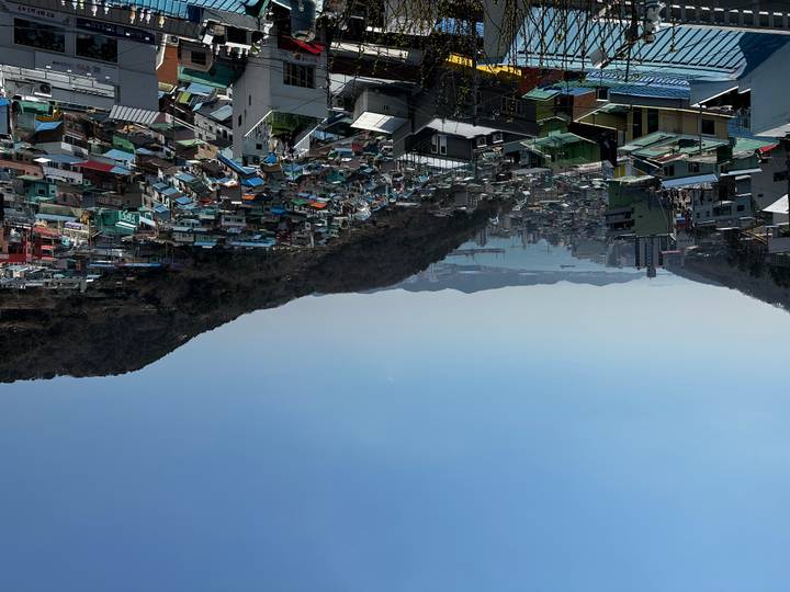 Panoramic view over colourful hillside houses of Gamcheon Culture Village with harbour beyond