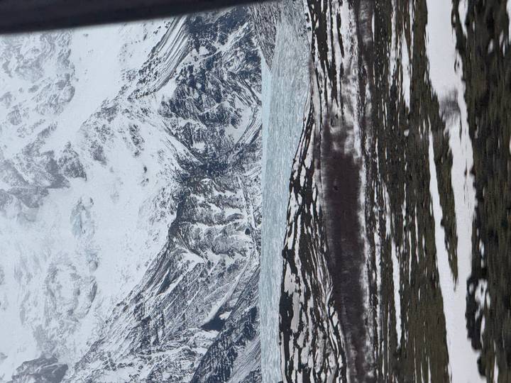 Jagged snowy mountains and glacier framed in vertical composition