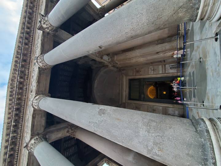 Visitors file into the mighty columns and bronze-roofed entrance of Rome's Pantheon.
