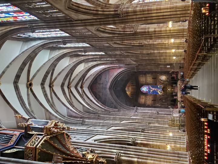 The soaring vaulted nave of Strasbourg Cathedral features intricate gothic arches and stained glass.