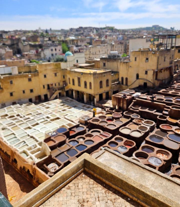 Blurry view over traditional dye vats of Fes tannery.