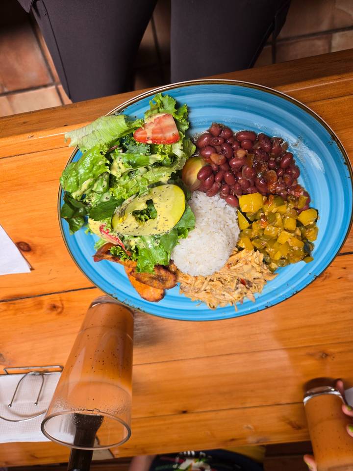 Colorful Costa Rican casado plate with rice, beans, salad, plantain and shredded chicken