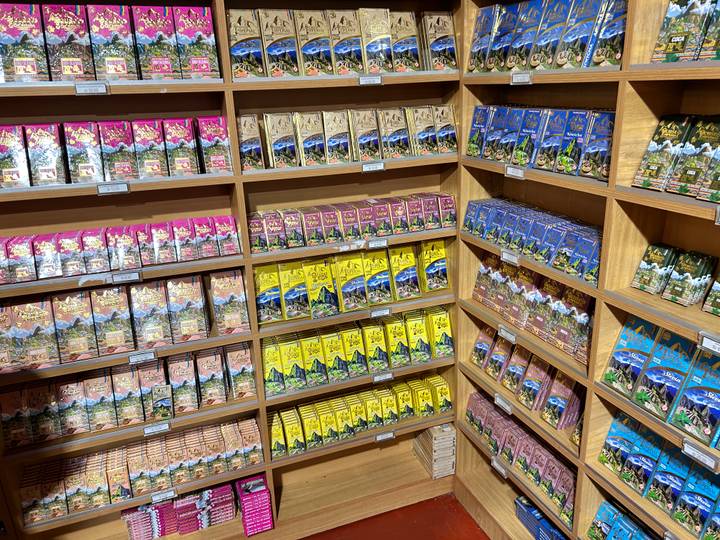 Colorful shelves stacked high with assorted packaged chocolates and sweets in a shop.