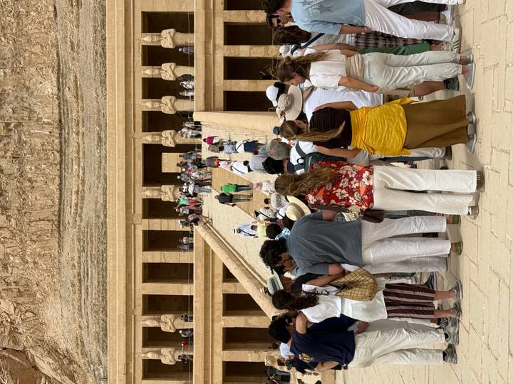 Crowds ascend the grand ramp of Hatshepsut’s Temple carved into desert cliffs.