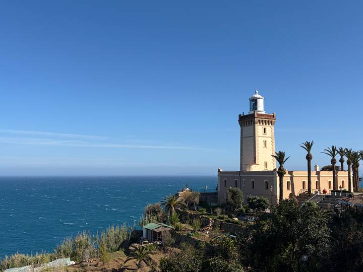 Coastal lighthouse overlooking the Atlantic Ocean on a clear day.
