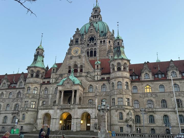 Elegant neo-Renaissance New Town Hall of Hanover with green copper domes and evening light.