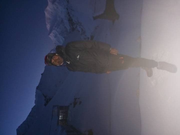 Blurry night portrait of trekker in snowy pass with fogged lens.