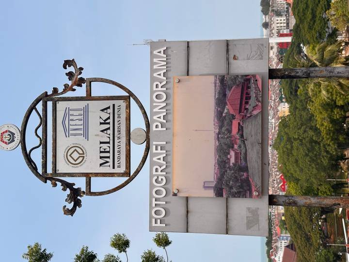 UNESCO heritage sign overlooking a panorama photo display of historic Melaka.