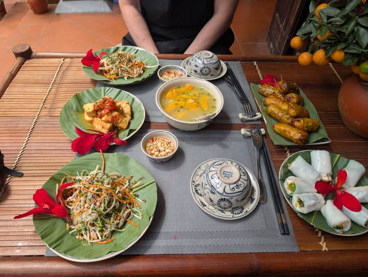 Traditional Vietnamese cooking class spread with vibrant vegetarian dishes on banana leaves