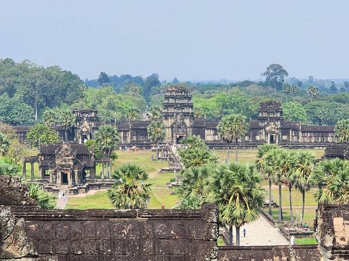 Expansive view of Angkor Wat’s ancient stone temples surrounded by lush greenery.