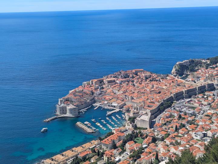 Stunning aerial panorama of Dubrovnik’s walled old town jutting into the deep blue Adriatic.