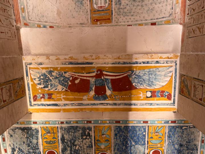 Colorful winged scarab relief decorating ceiling of ancient Egyptian tomb