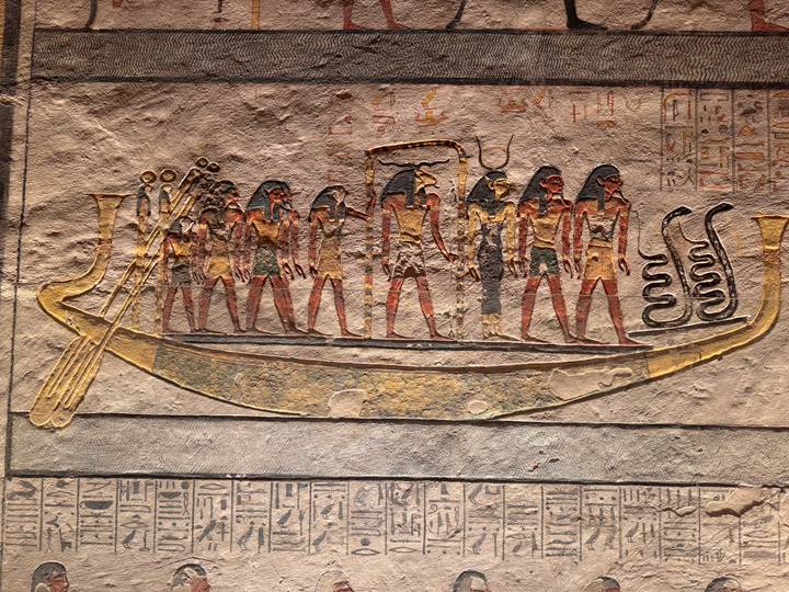Ancient Egyptian wall painting of deities aboard solar boat