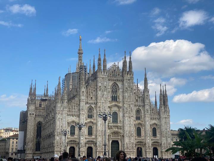 Detailed frontal view of Milan's ornate Gothic cathedral under a bright sky