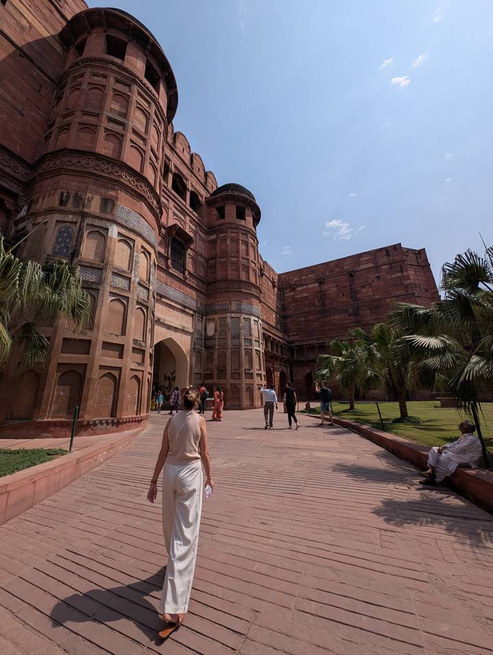 Visitors walking through the red-sandstone gateways and courtyards of Agra Fort
