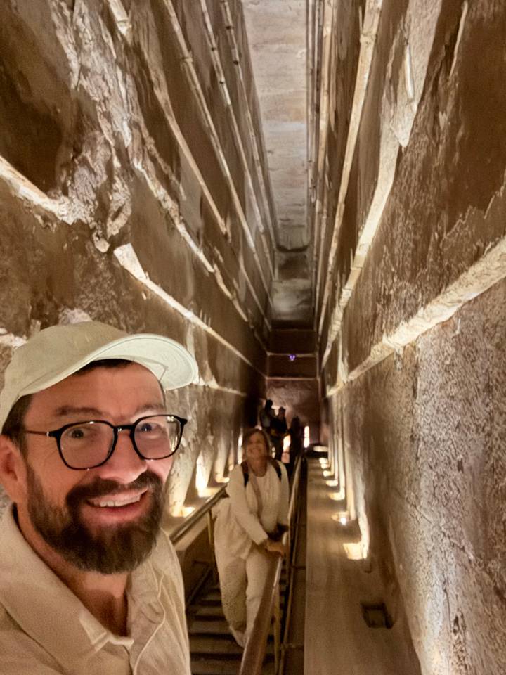 Excited travelers inside the narrow sloping passageway of the Great Pyramid