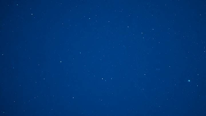 Long-exposure shot of a deep blue night sky sprinkled with countless stars