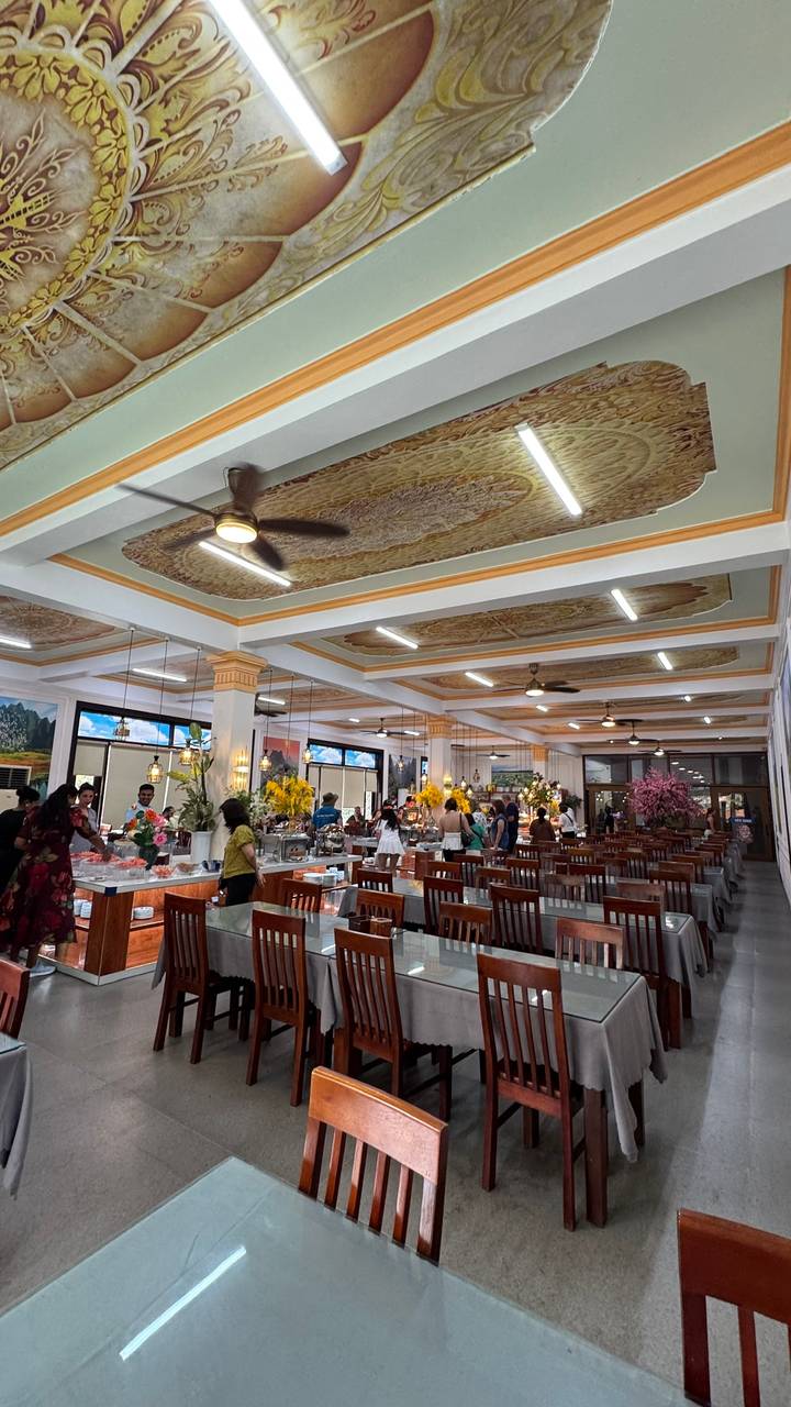 Spacious Vietnamese buffet restaurant with ornate ceiling panels and diners serving themselves