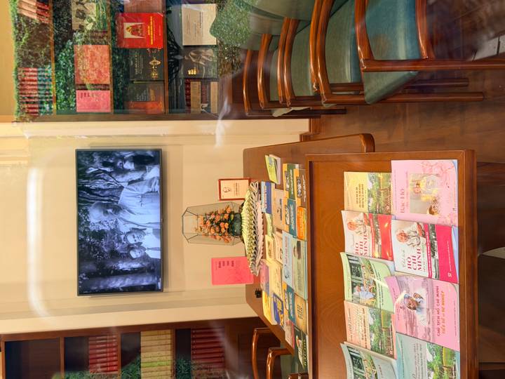 Museum room displaying books, memorabilia and a video about Ho Chi Minh.