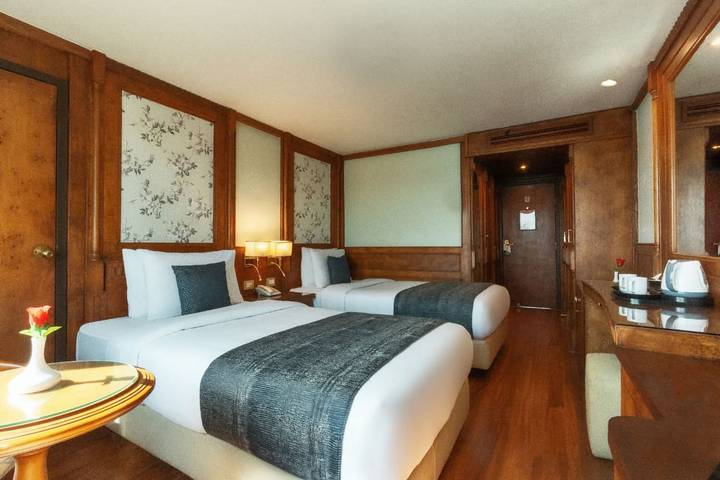 Warmly decorated twin cabin with wood paneling, soft lighting and modern amenities.