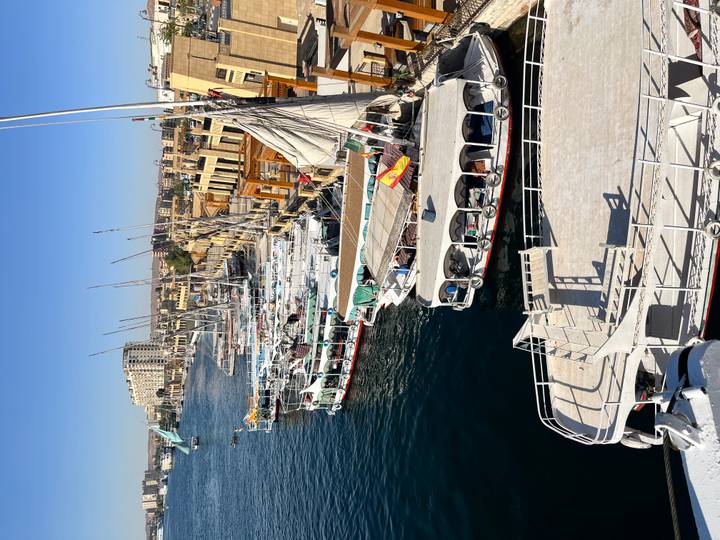 Row of white-topped feluccas and cruise boats moored along the Nile waterfront in Aswan.
