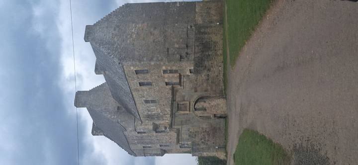 Grey stone Midhope-style castle with stepped gables under brooding sky at end of track.