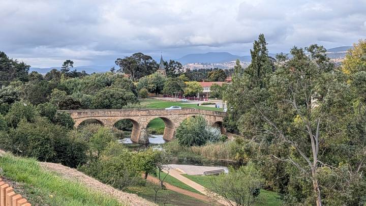 Historic sandstone Richmond Bridge spans a leafy river valley in Tasmania.