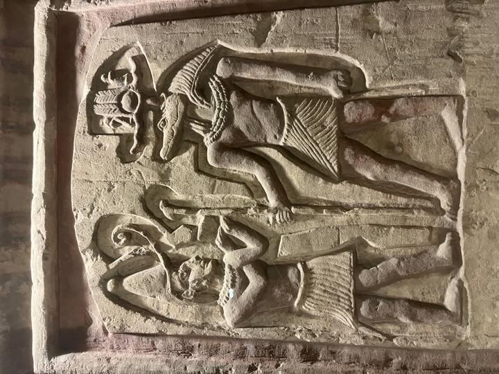 Stone relief showing Sobek and another figure in an Egyptian temple.