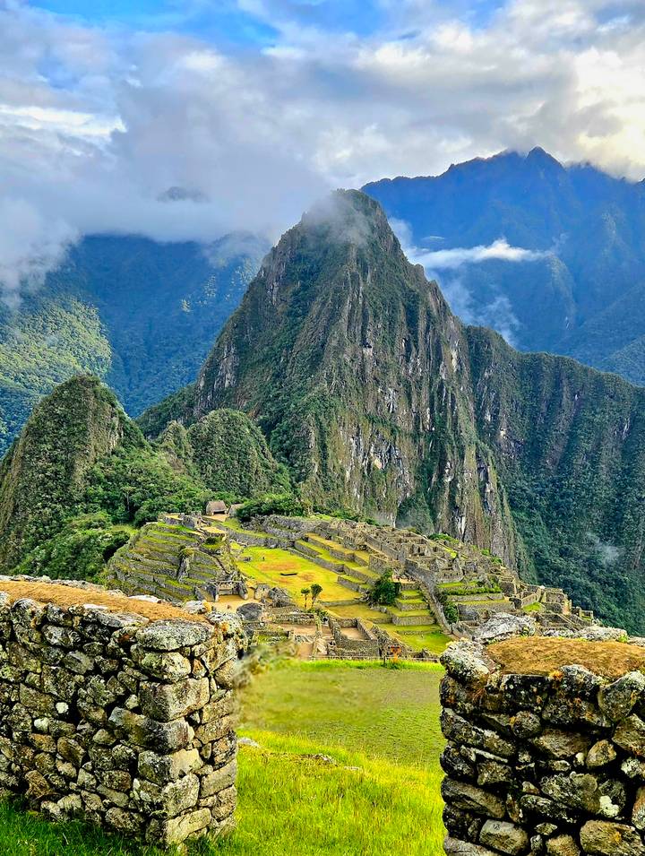 Classic panoramic view of Machu Picchu ruins nestled among steep green Andean peaks