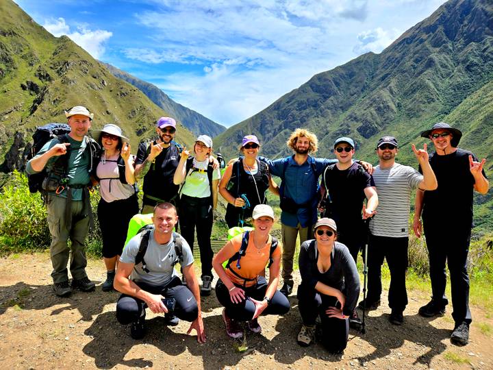 Daytime group portrait on the trail with dramatic green canyon backdrop
