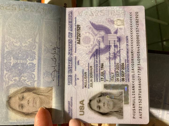 Open United States passport showing personal identification page with photo and security hologram.