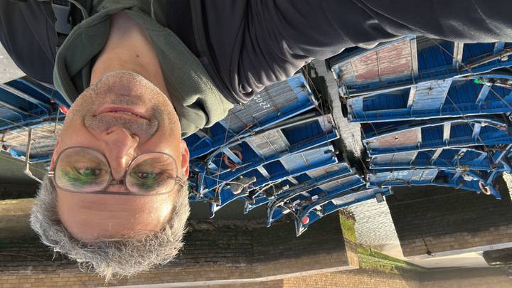Selfie overlooking rows of bright blue wooden fishing boats moored in Essaouira’s harbor.