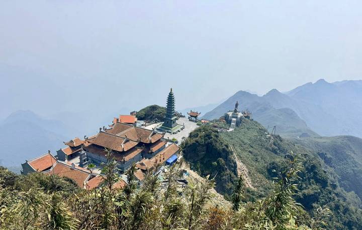 Mountain-top pagoda complex with hazy view over the Hoang Lien mountains