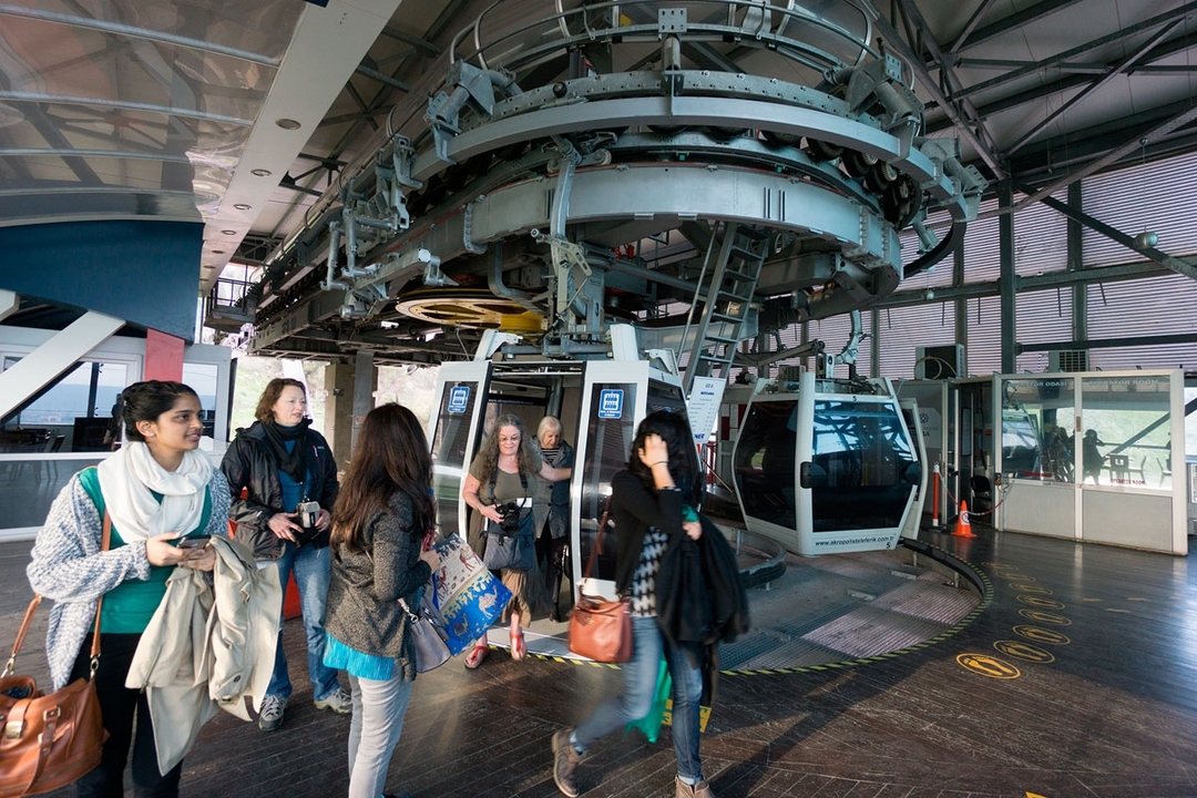 People inside a gondola lift looking out.
