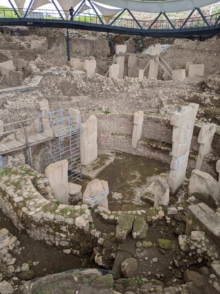 Closer view of ancient circular stone structures and monumental pillars at Göbekli Tepe archaeological site.