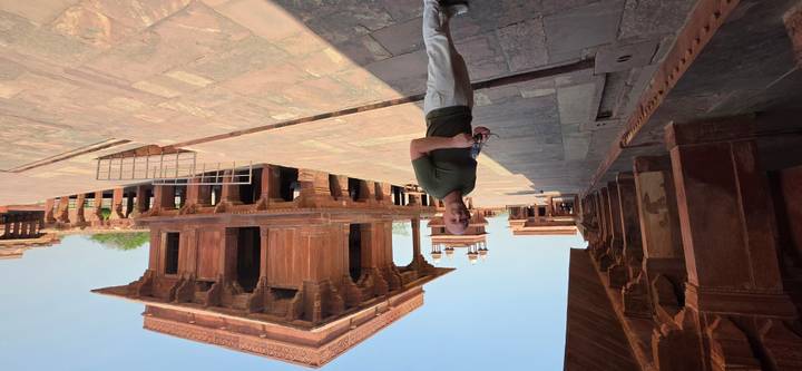A visitor explores the red-sandstone pavilions of Fatehpur Sikri’s royal complex.