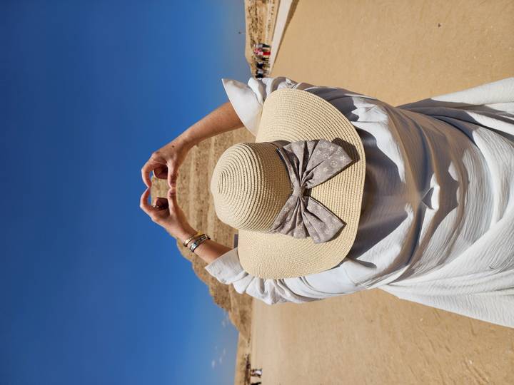 Traveller forms a heart with her hands toward the Step Pyramid at Saqqara.