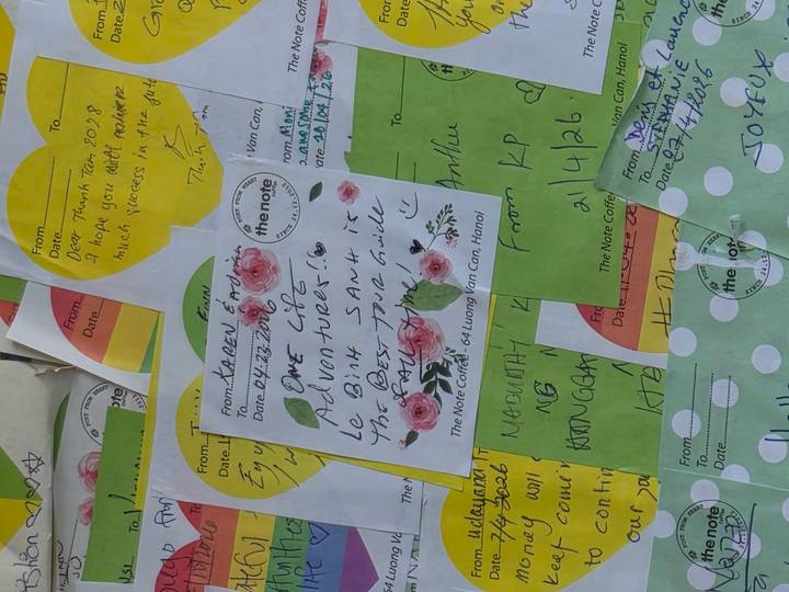 Assorted handwritten note cards layered together with colorful designs.